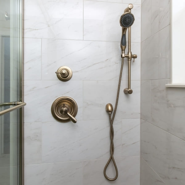 Brushed Gold Shower Hardware with Double Sprayer in Walk-In Shower with Natural Light | Louisville Handyman and Remodeling